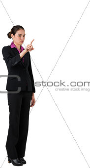 Serious businesswoman in suit pointing