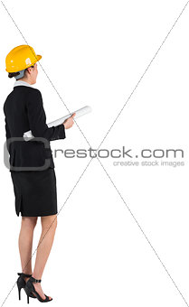 Smiling architect in black suit holding blueprint
