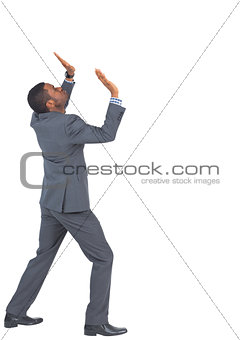 Businessman standing and pushing up