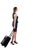 Redhead businesswoman pulling her suitcase
