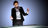 Redhead businesswoman standing and gesturing by a desk
