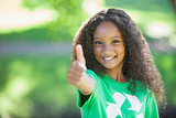 Young environmental activist smiling at the camera showing thumbs up