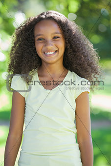 Young girl smiling at the camera in the park