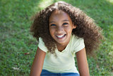 Young girl smiling at the camera in the park