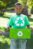 Young boy in recycling tshirt holding box