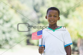 Little boy celebrating independence day in the park