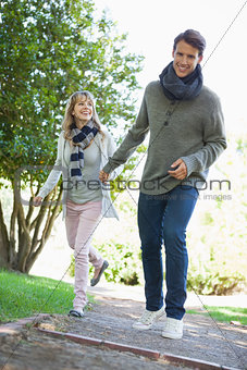 Cute couple walking hand in hand in the park