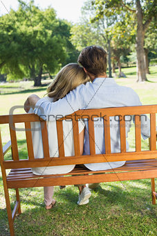 Couple relaxing on park bench together
