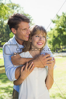 Cute couple hugging in the park and smiling