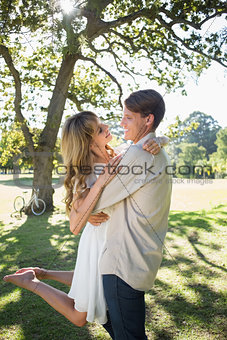 Smiling couple embracing in park