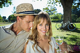 Cute couple drinking white wine on a picnic woman smiling at camera