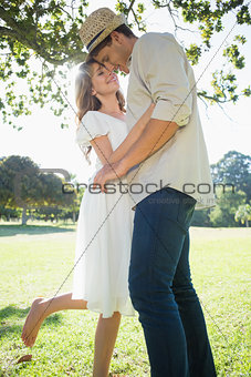 Cute couple standing in the park embracing