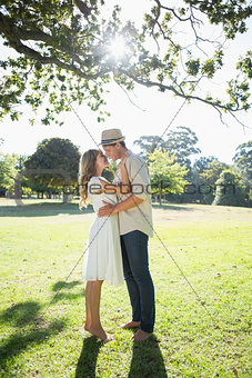 Attractive couple standing and embracing in park