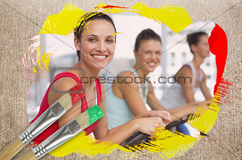 Composite image of spinning class in the gym