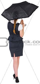 Pretty redhead businesswoman holding umbrella