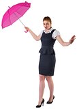 Pretty redhead businesswoman holding umbrella