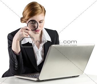 Redhead businesswoman using her laptop