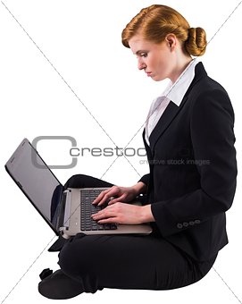 Redhead businesswoman using her laptop