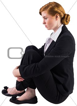 Unhappy redhead businesswoman sitting