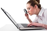 Attentive businesswoman typing on laptop