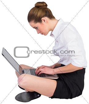 Businesswoman sitting on floor using laptop
