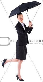 Businesswoman holding a black umbrella