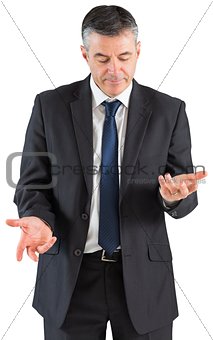 Mature businessman holding his hands out