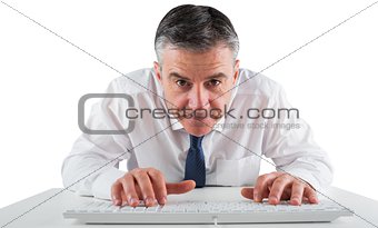 Mature businessman typing on keyboard