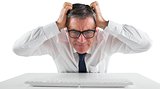 Stressed businessman using a keyboard