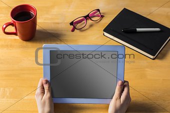 Businesswoman using tablet at desk