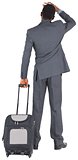 Young businessman standing with suitcase