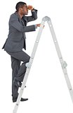 Businessman standing on ladder looking