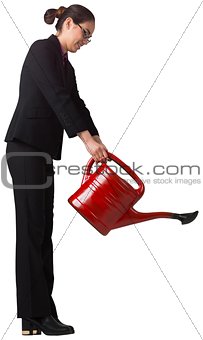 Businesswoman using red watering can