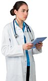 Young doctor standing with tablet pc