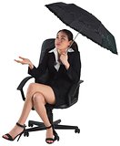 Young businesswoman holding umbrella