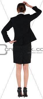 Young businesswoman standing and thinking