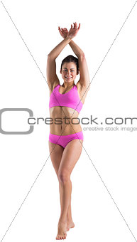 Fit girl in pink bikini posing