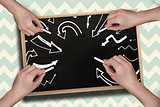 Composite image of multiple hands drawing arrows with chalk