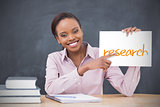 Happy teacher holding page showing research