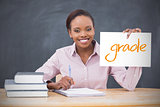 Happy teacher holding page showing grade