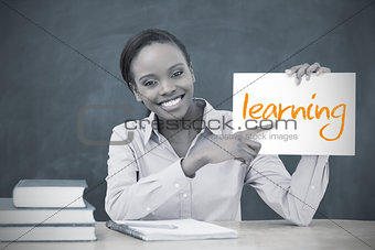 Happy teacher holding page showing learning