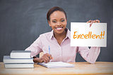 Happy teacher holding page showing excellent