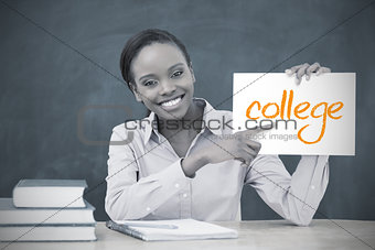 Happy teacher holding page showing college