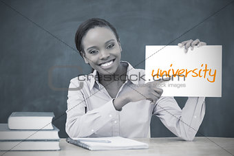 Happy teacher holding page showing university