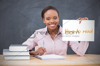 Happy teacher holding page showing time to read