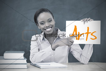 Happy teacher holding page showing arts