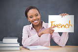 Happy teacher holding page showing french