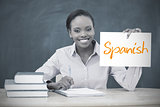 Happy teacher holding page showing spanish