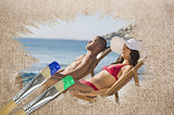 Composite image of couple lying on the beach