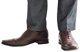 Businessmans feet in brown brogues
